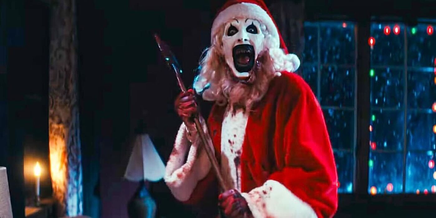 David Howard Thornton as Art the Clown holding an axe and laughing in Terrifier 3.