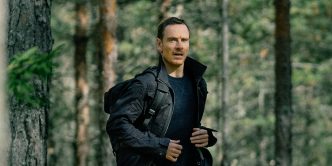 Michael Fassbender running through the woods in The Agency