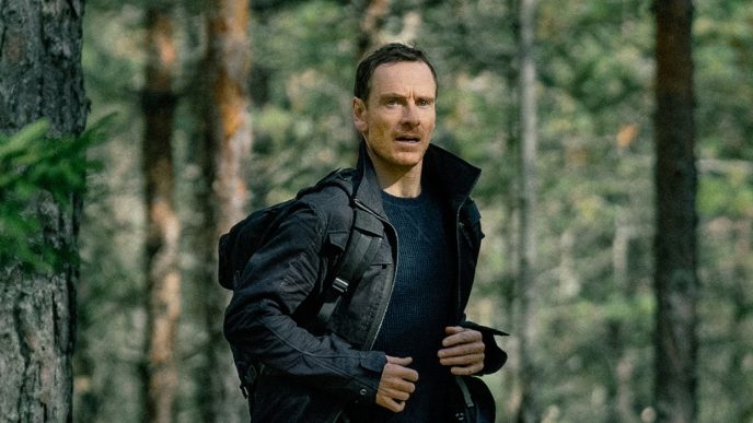 Michael Fassbender running through the woods in The Agency