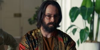 Martin Starr as Bodhi wearing a patterned shirt, tilting his head slightly down, in Tulsa King Season 1, Episode 9.