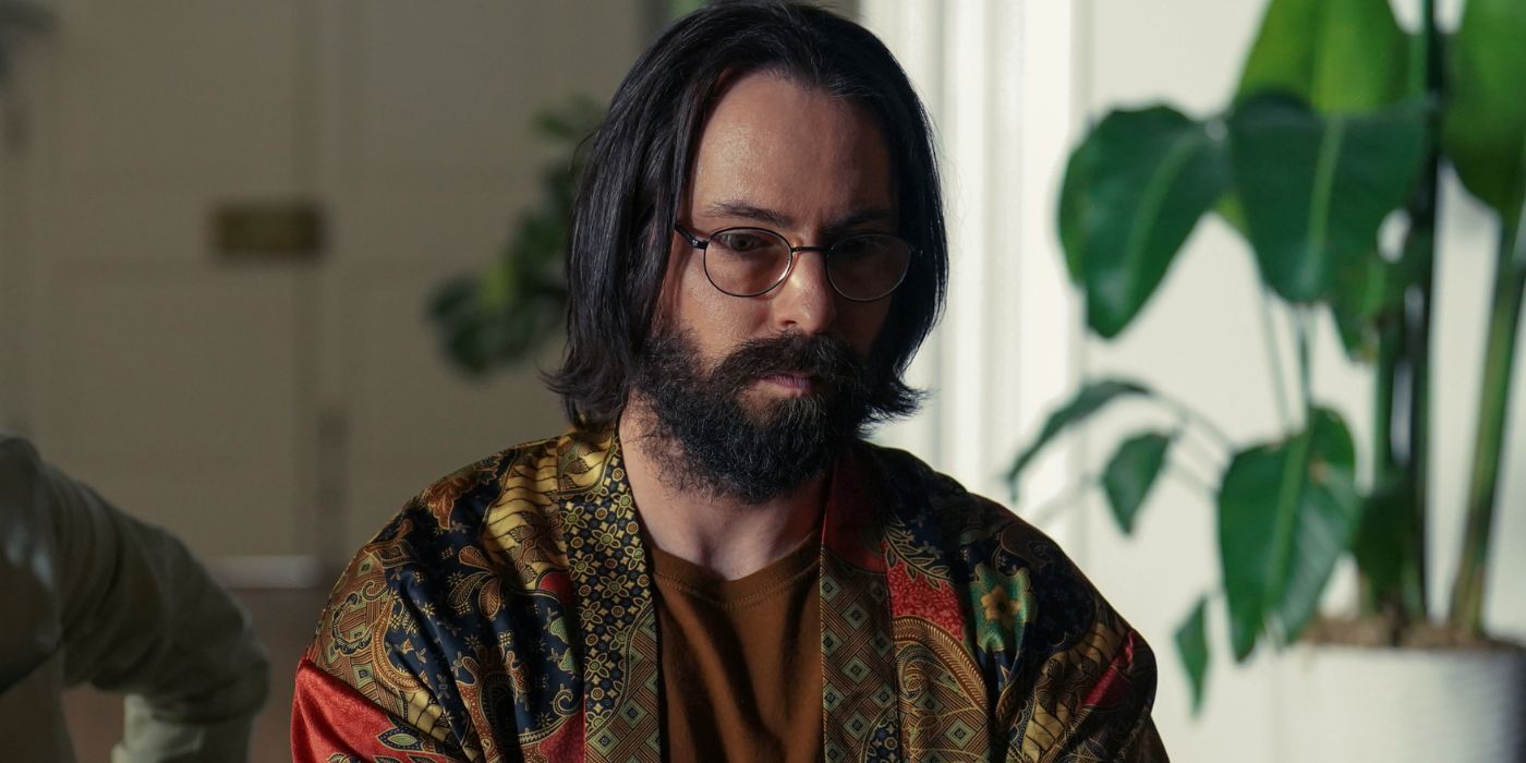 Martin Starr as Bodhi wearing a patterned shirt, tilting his head slightly down, in Tulsa King Season 1, Episode 9.