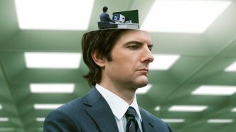 Promo image for Severance showing Adam Scott with a small version of himself in front of a computer screen emerging from atop his head.