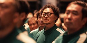 in his green uniform and glasses Yang Dong-geun stands at attention in