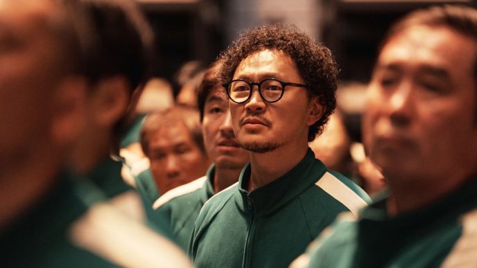 in his green uniform and glasses Yang Dong-geun stands at attention in