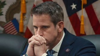 Adam Kinzinger sits, hands folded at his chin, in The Last Republican