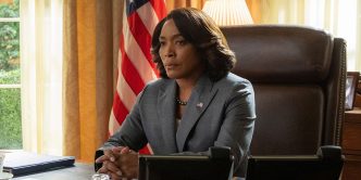 Angela Bassett sitting in the Oval Office in