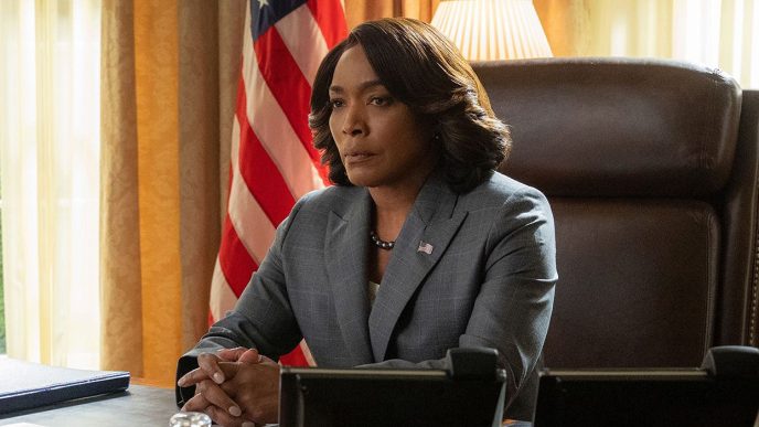 Angela Bassett sitting in the Oval Office in