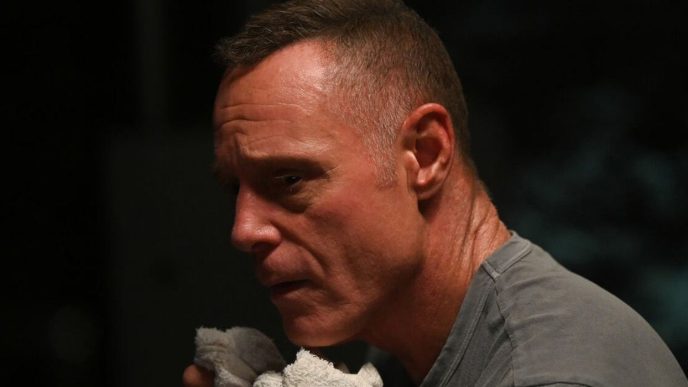 Jason Beghe as Voight holding a rag to his mouth in Chicago PD Season 12